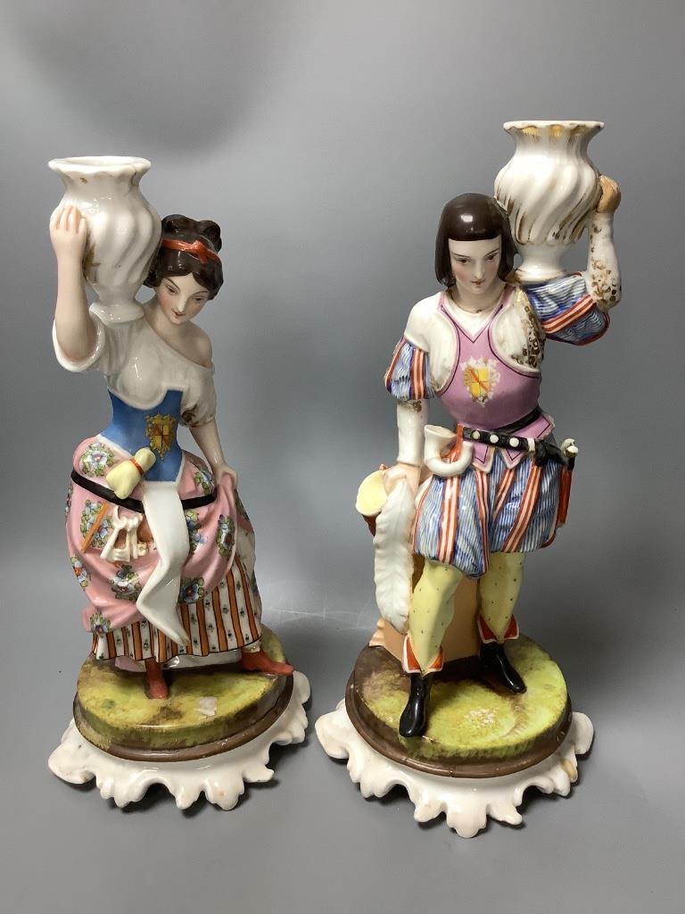 A pair of Italian porcelain figures and a pair of Continental figural candlesticks